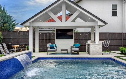 Blue outdoor pool and kitchen
