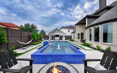 Blue outdoor pool and firepit