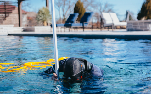 man performing pool leak detection