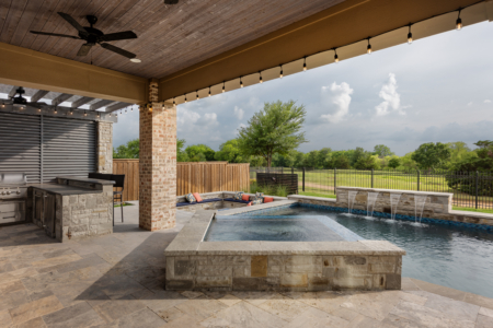 Rectangular spa above a pool with fountains