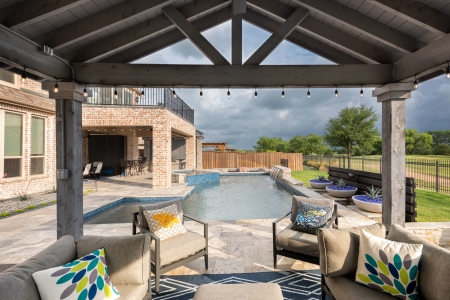 Outdoor sitting area with a pool on a cloudy day