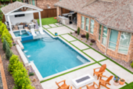 Aerial view of a pool and firepit and chairs