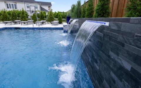 Waterfall pouring into a blue pool