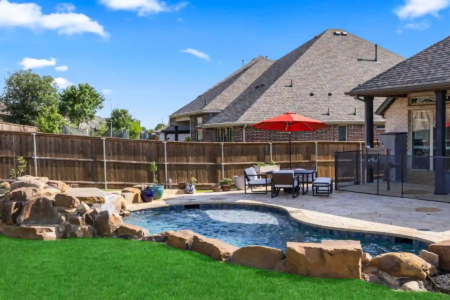 Green grass near rocks and a pool