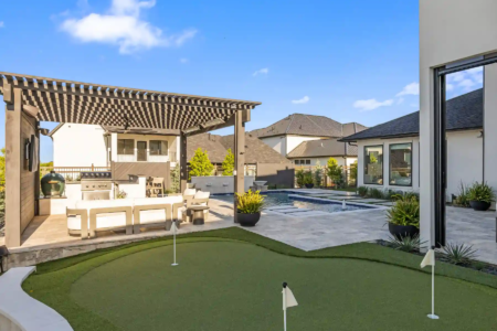 Small putting course near an outdoor kitchen