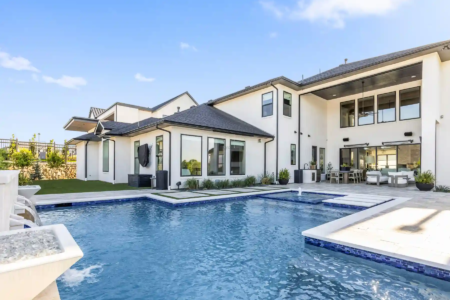 Close up of a pool and mansion