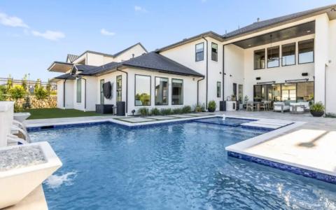 Close up of a pool and mansion