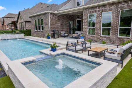 Hot tub with a fountain above a pool