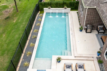 Aerial view of a pool, hot tub, and outdoor space